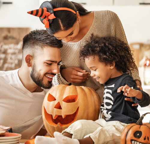 family looking at a pumpkin